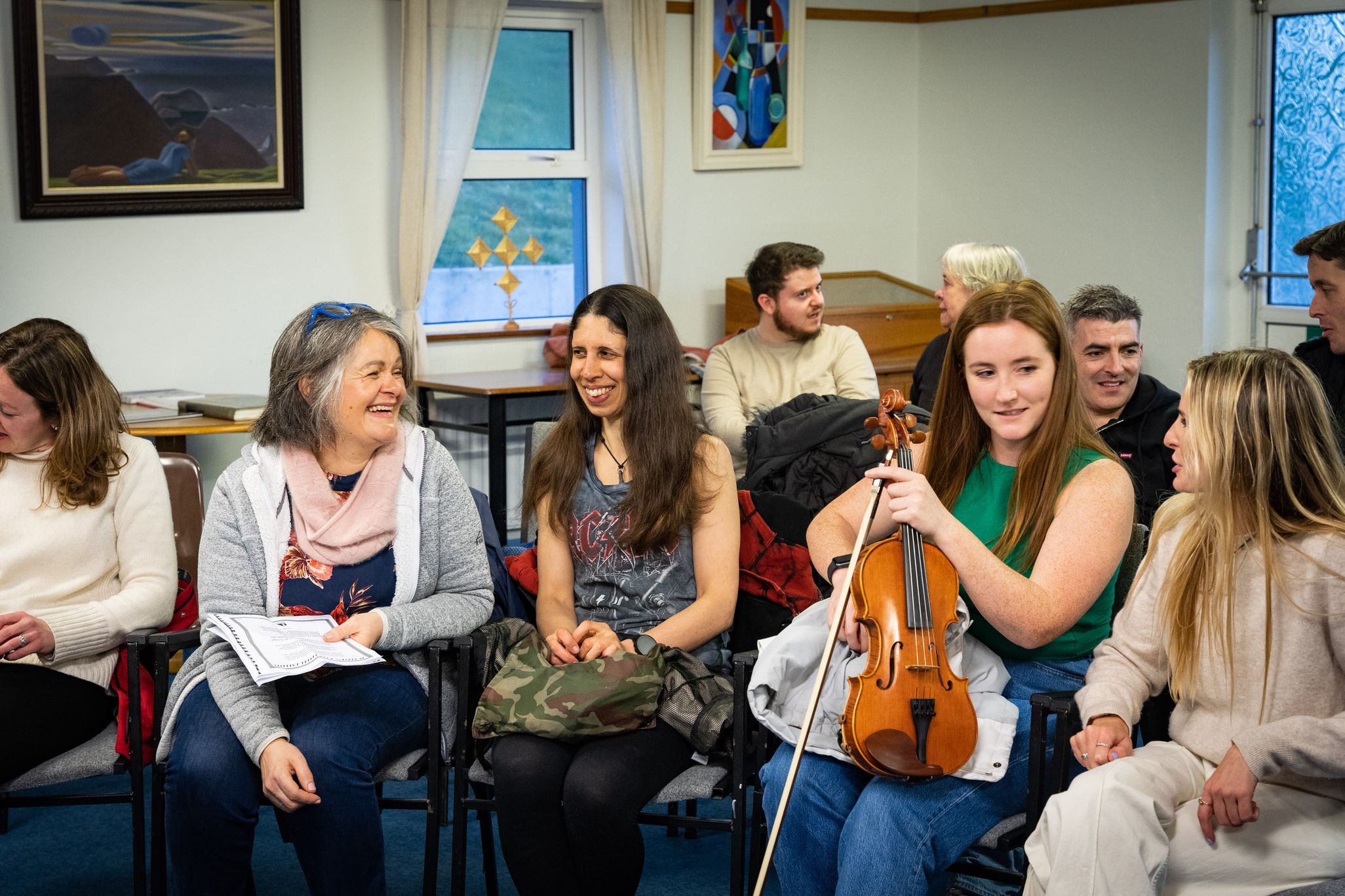 Participant from Ireland, Finland and the USA talking and laughing during an Oideas Gael course